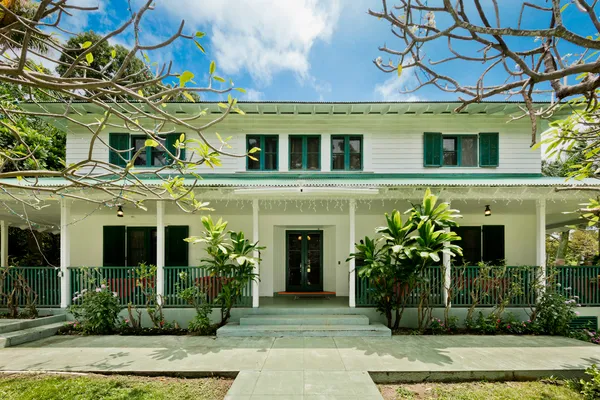 a front view of a house with plants