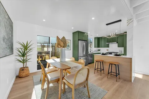 a dining room with furniture and wooden floor
