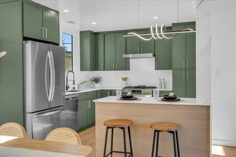a bathroom with a sink a mirror and a refrigerator