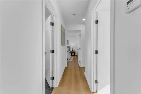 a view of a hallway with wooden shelves