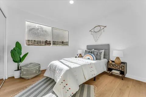 a bedroom with bed and a window