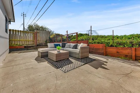 a patio with patio a couch and chairs
