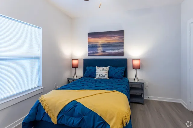 a bedroom with a bed and a night stand