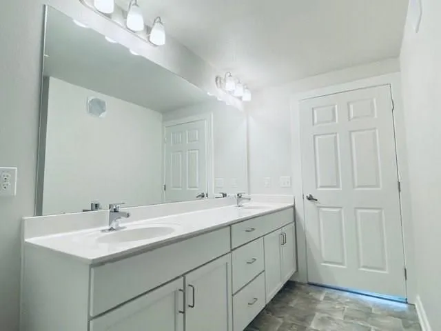 a bathroom with 2 sink and a mirror