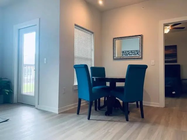 a view of a dining room with furniture and wooden floor