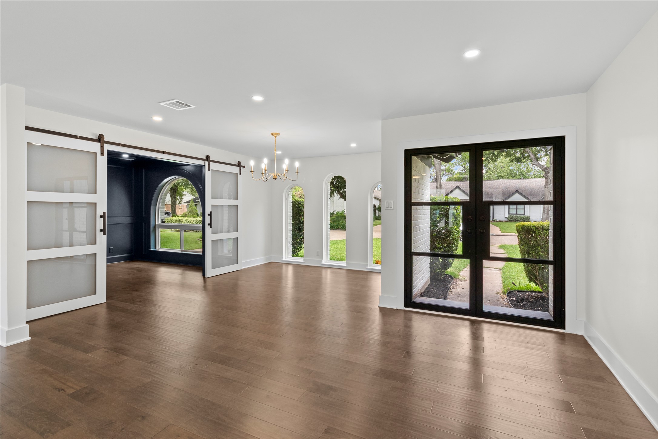 2823 Stetson Lane Houston, TX 77043 - Photo 2 of 19 an empty room with large window and wooden floor
