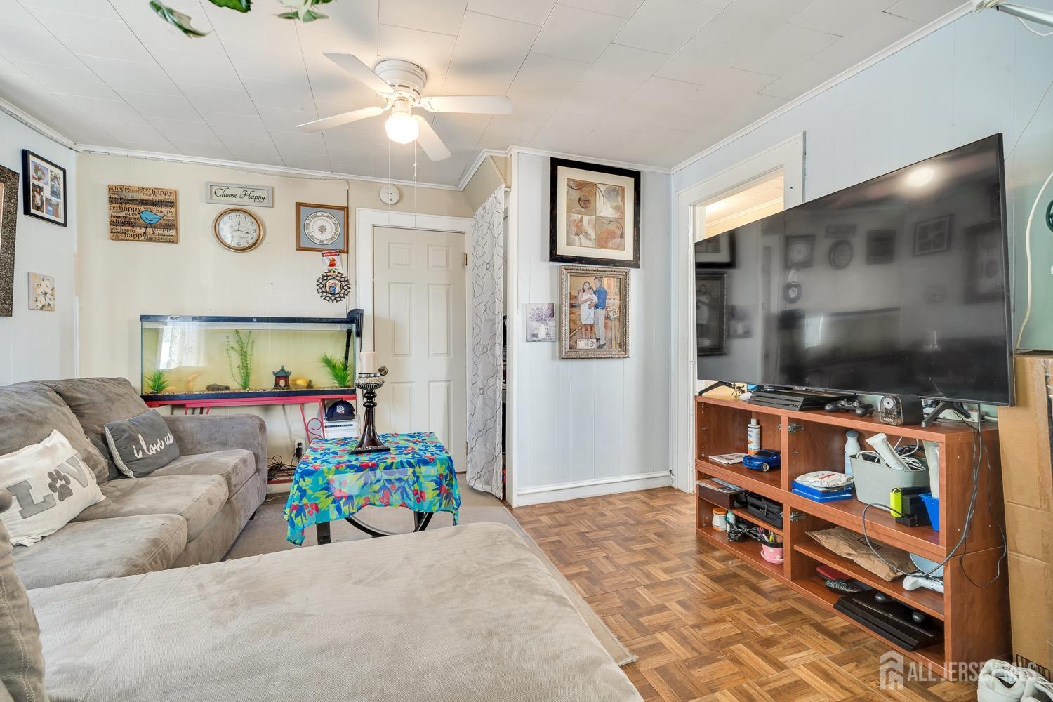 64 Commerce Street Perth Amboy, NJ 08861 - Photo 13 of 25 a living room with furniture and a flat screen tv