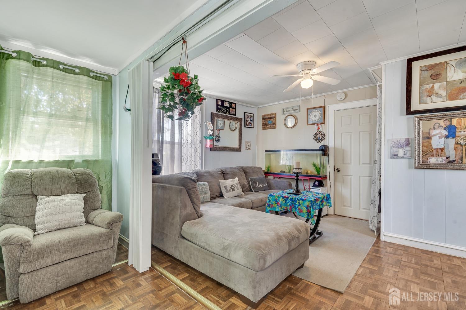 64 Commerce Street Perth Amboy, NJ 08861 - Photo 14 of 25 a living room with furniture and a potted plant