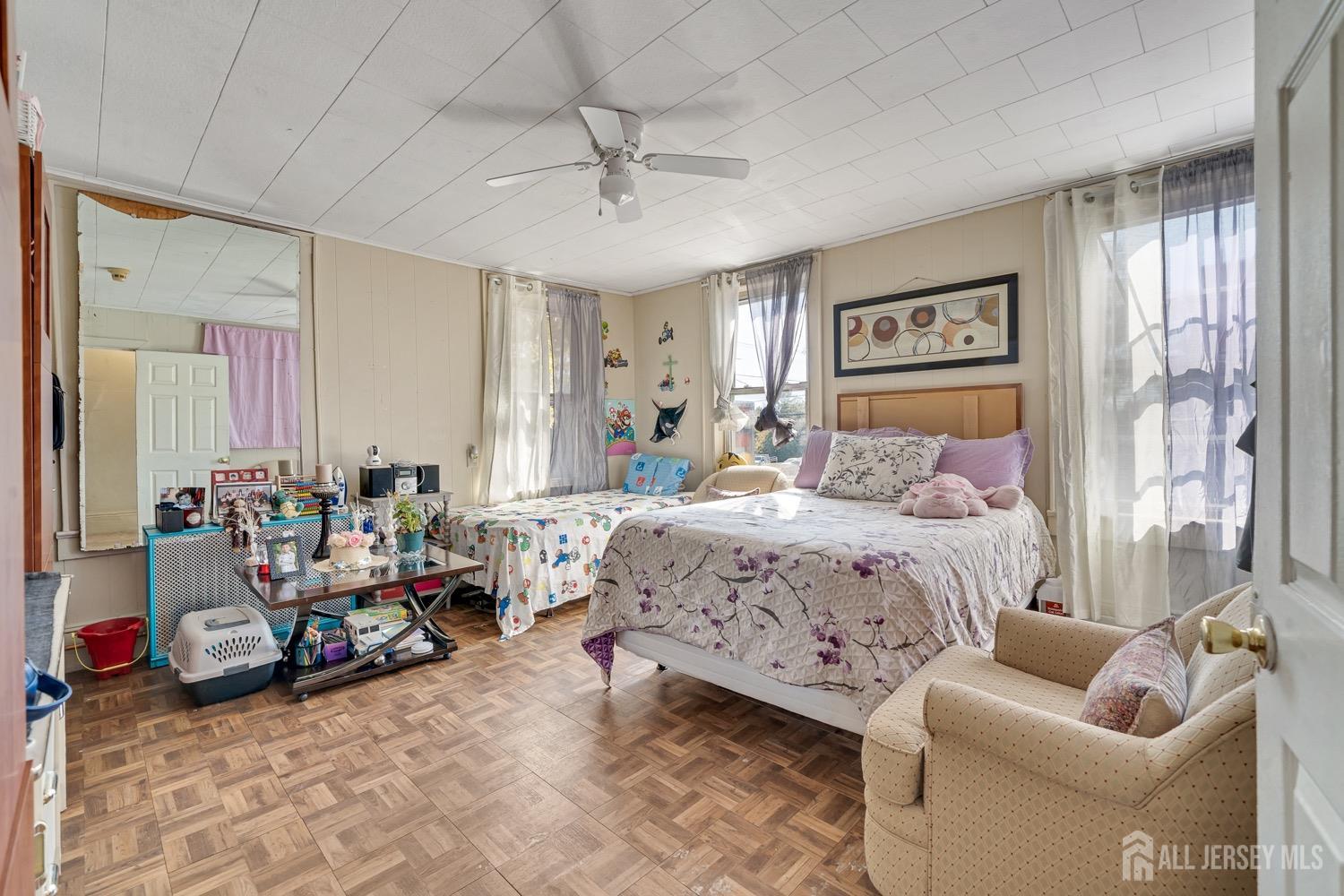 64 Commerce Street Perth Amboy, NJ 08861 - Photo 15 of 25 a bedroom with furniture and a large window