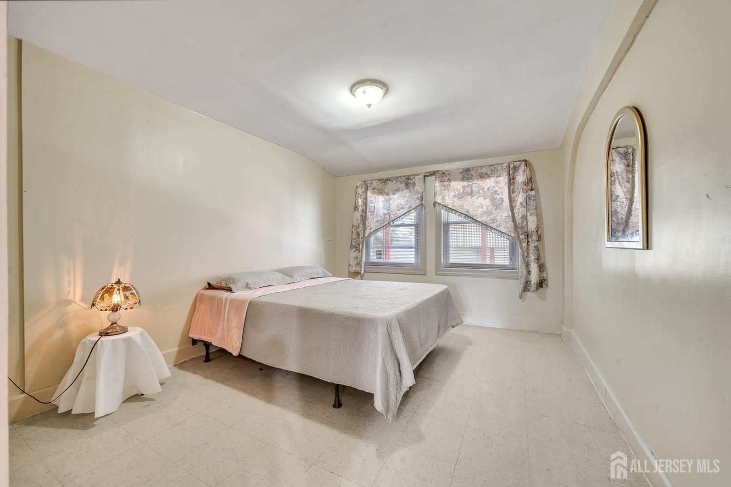 64 Commerce Street Perth Amboy, NJ 08861 - Photo 16 of 25 a bedroom with a bed and a window