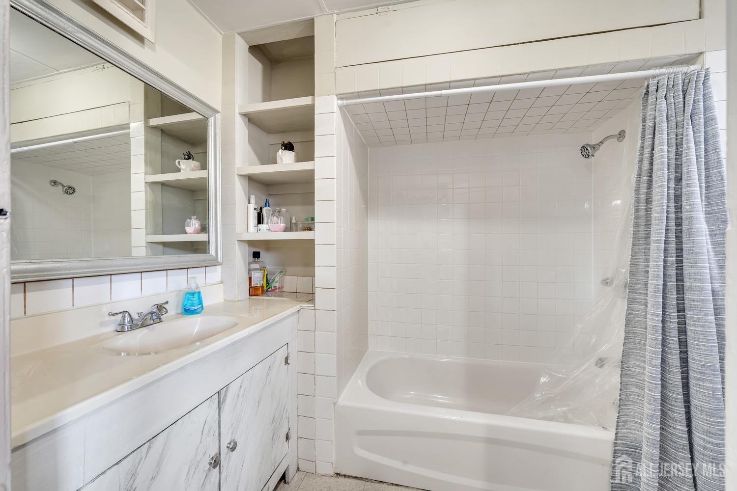 64 Commerce Street Perth Amboy, NJ 08861 - Photo 17 of 25 a bathroom with a bathtub and a sink