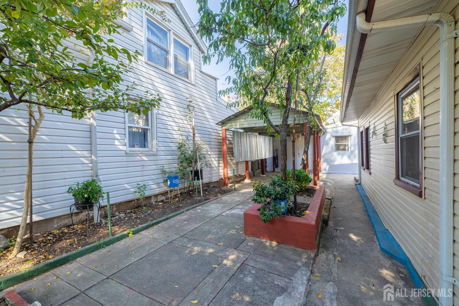 64 Commerce Street Perth Amboy, NJ 08861 - Photo 9 of 25 a front view of a house with garden
