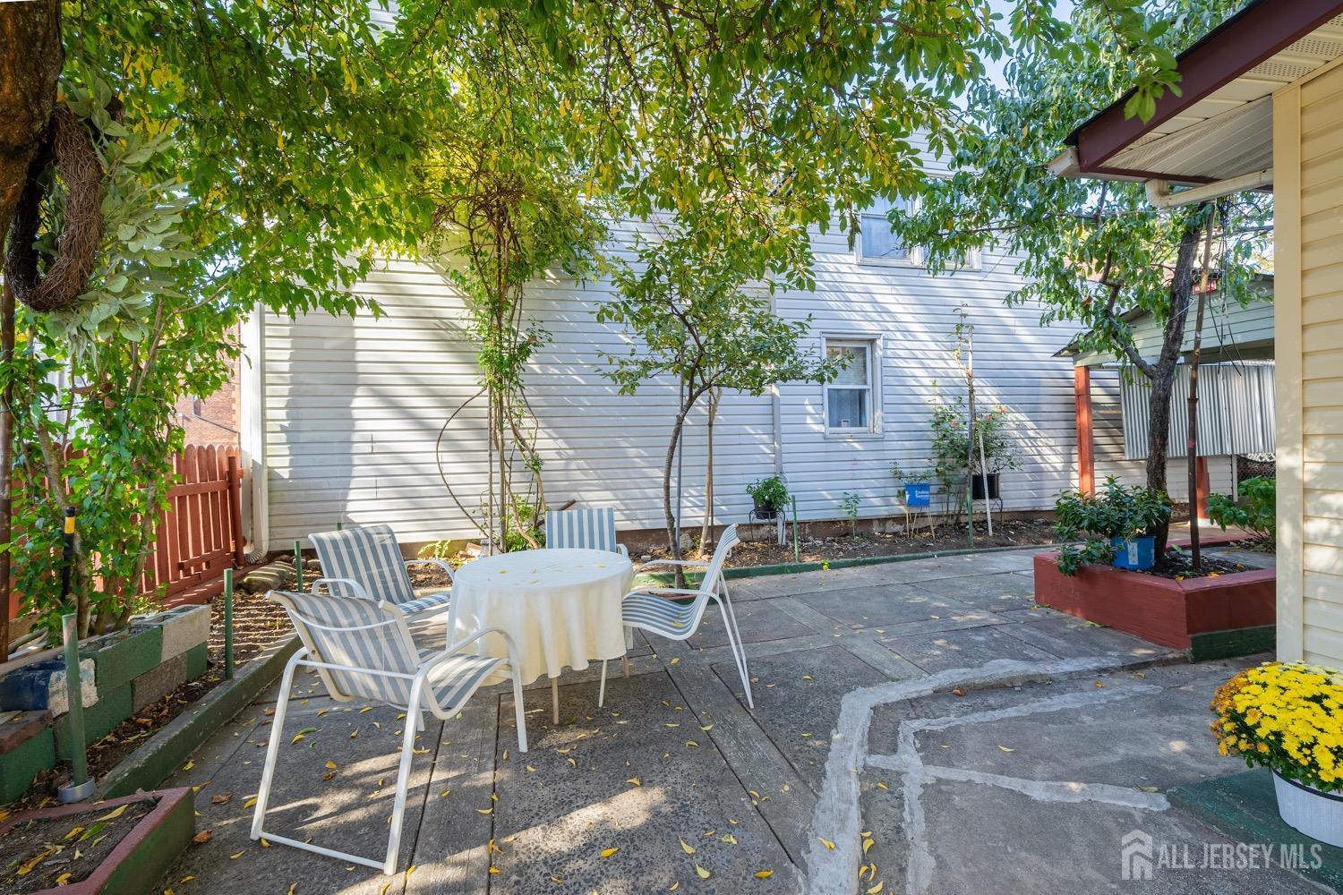 64 Commerce Street Perth Amboy, NJ 08861 - Photo 10 of 25 a view of a patio with table and chairs and potted plants