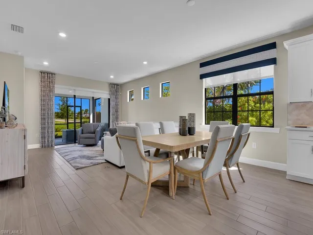 a view of a dining room with furniture window and wooden floor