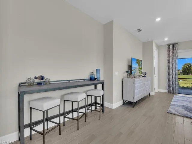a view of a workspace with furniture and wooden floor