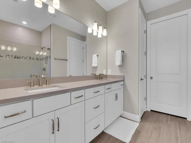 a bathroom with double sink and a mirror