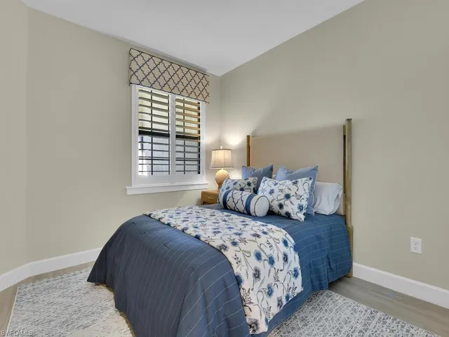 a bedroom with double bed and a window