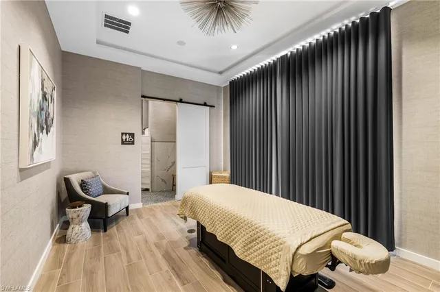 a bedroom with a bed and a chair