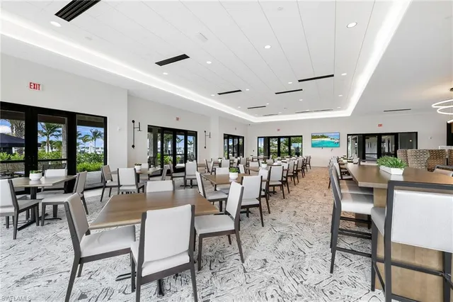 a living room with lots of furniture and view of kitchen
