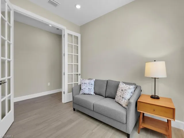 a living room with furniture and a lamp