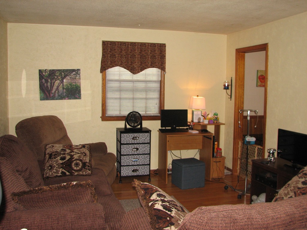 30-32 Pondover Road Billerica, MA 01821 - Photo 8 of 19 a living room with furniture a fireplace and a flat screen tv