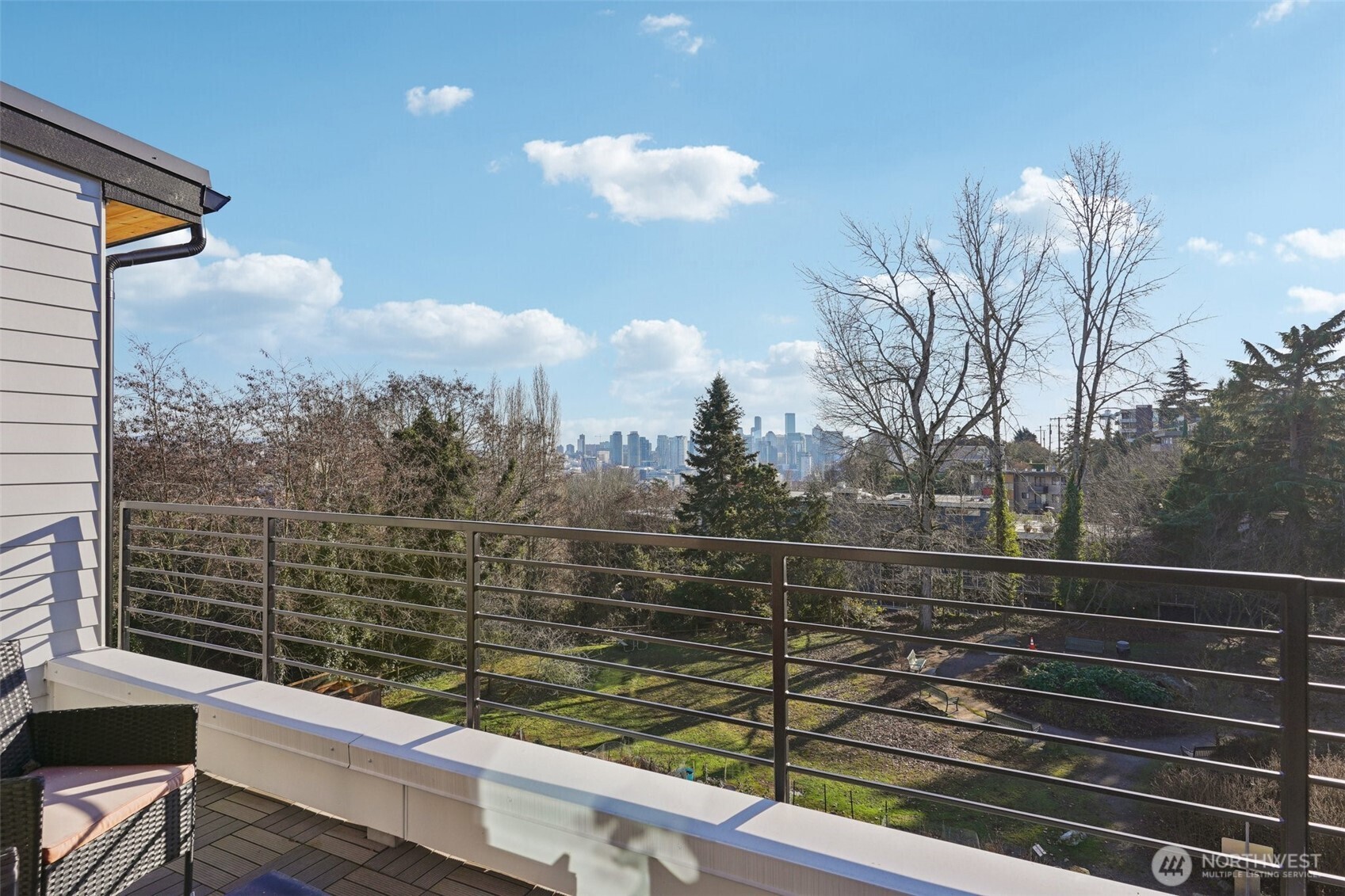 515 Howe Street, Unit A Seattle, WA 98109 - Photo 17 of 40 a view of a balcony with wooden floor and fence