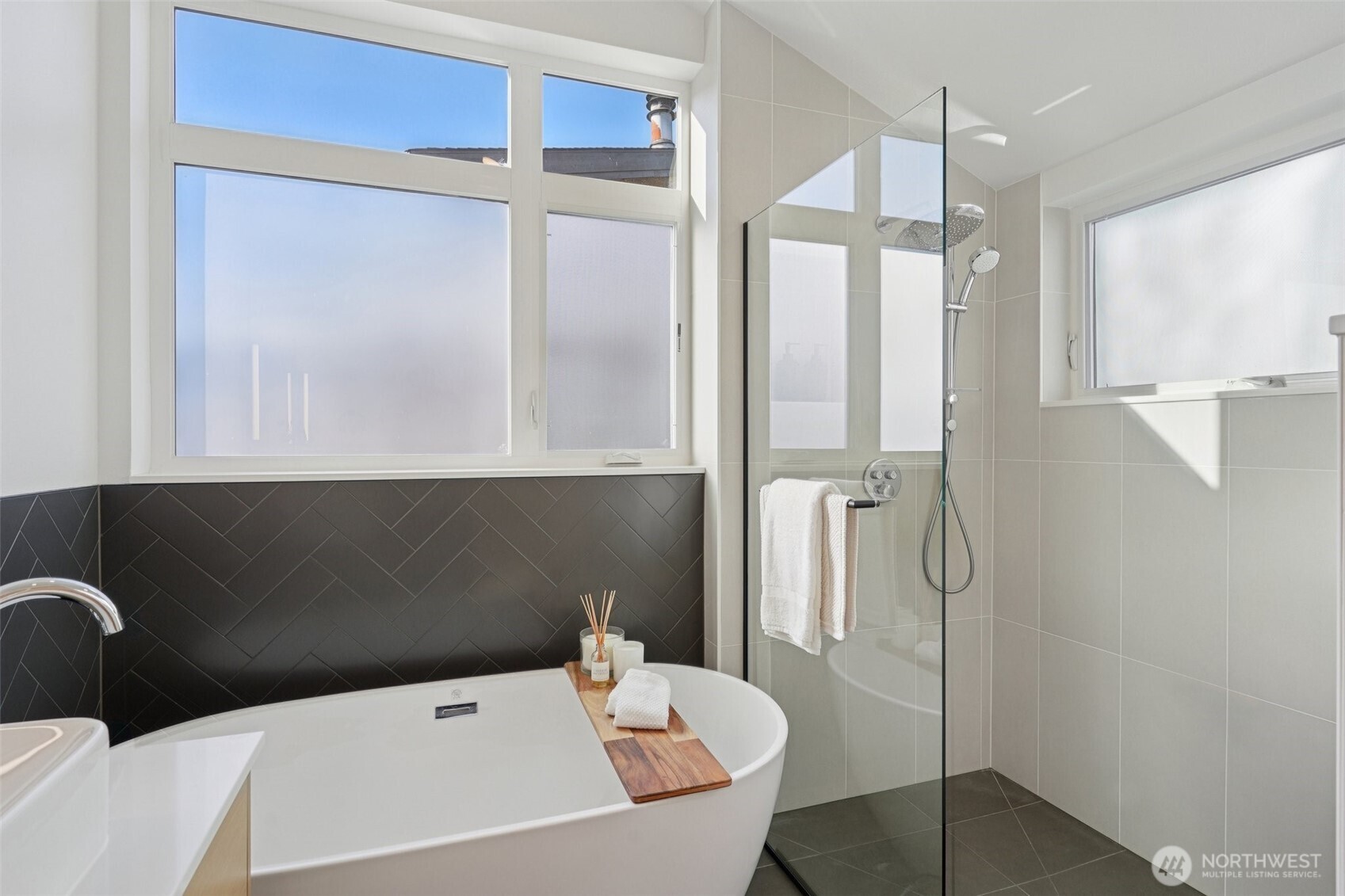 515 Howe Street, Unit A Seattle, WA 98109 - Photo 19 of 40 a bathroom with a bathtub and a shower