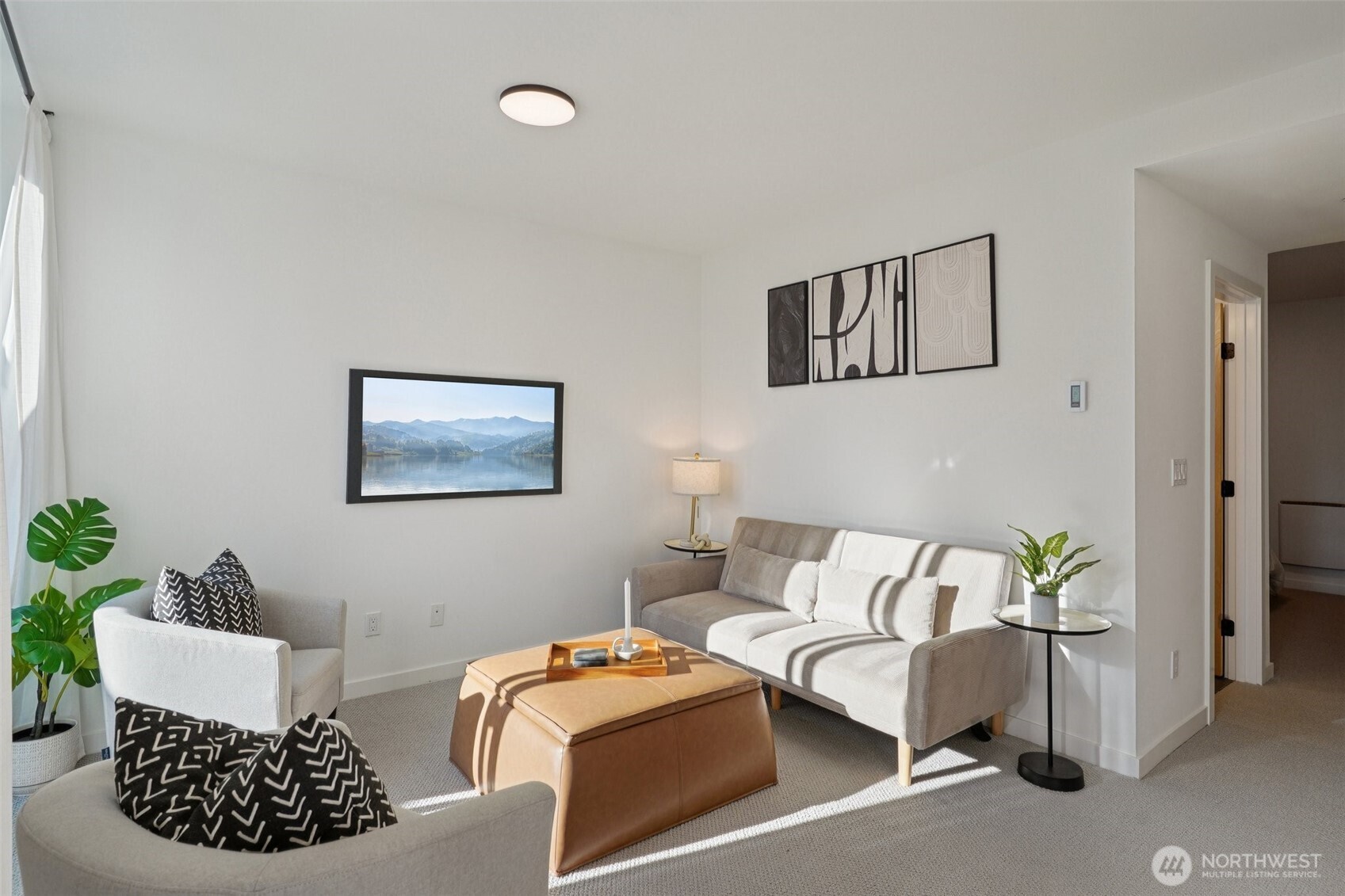 515 Howe Street, Unit A Seattle, WA 98109 - Photo 22 of 40 a living room with furniture and a wooden floor
