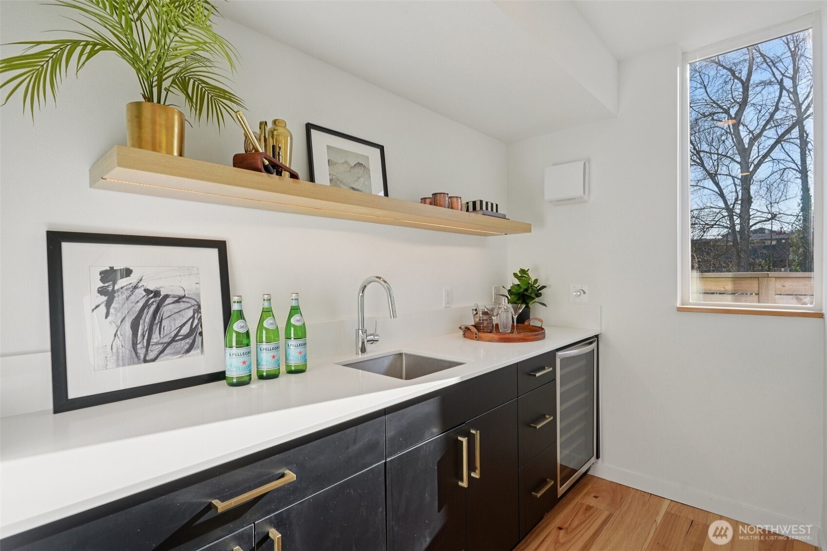 515 Howe Street, Unit A Seattle, WA 98109 - Photo 23 of 40 a kitchen with a sink and a stove with wooden floor
