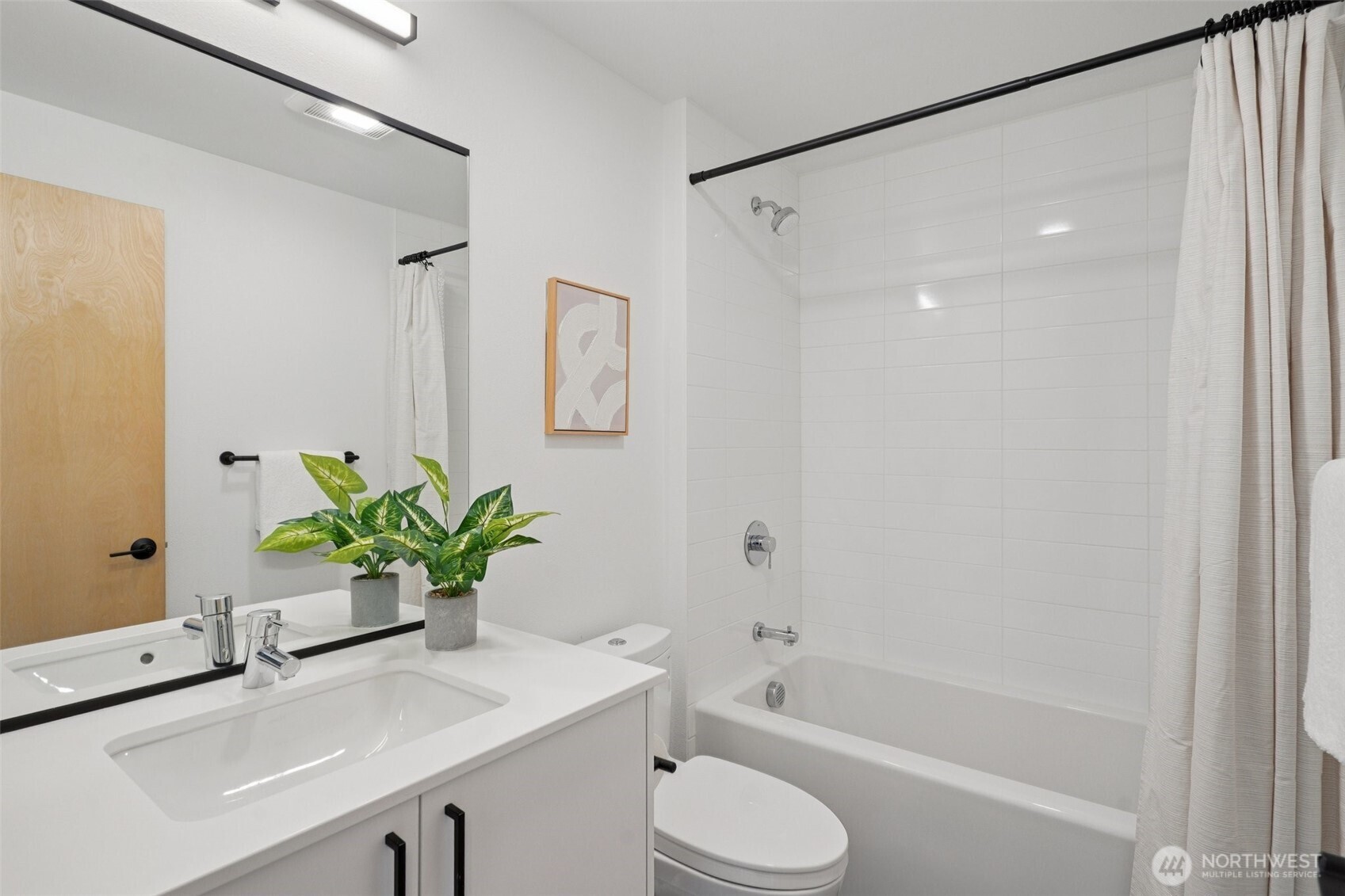 515 Howe Street, Unit A Seattle, WA 98109 - Photo 25 of 40 a bathroom with a sink a toilet a shower and a mirror