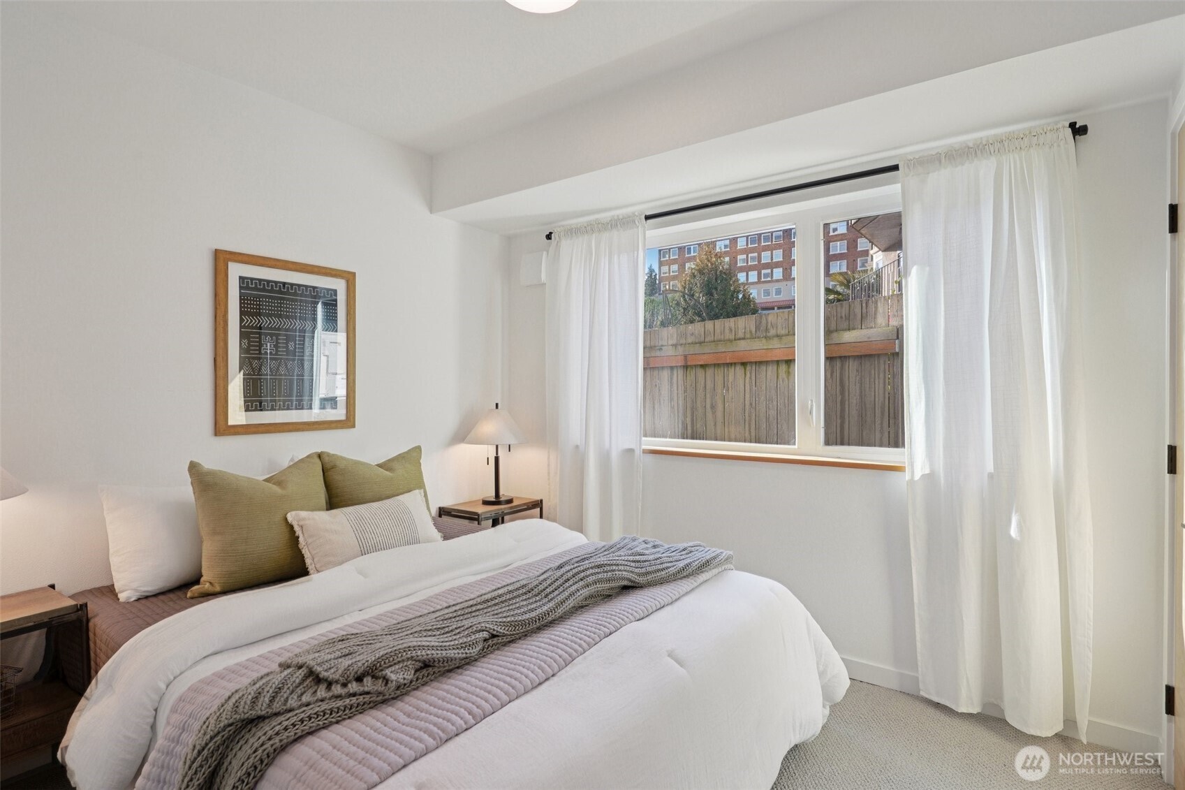 515 Howe Street, Unit A Seattle, WA 98109 - Photo 29 of 40 a bedroom with a bed and a large window