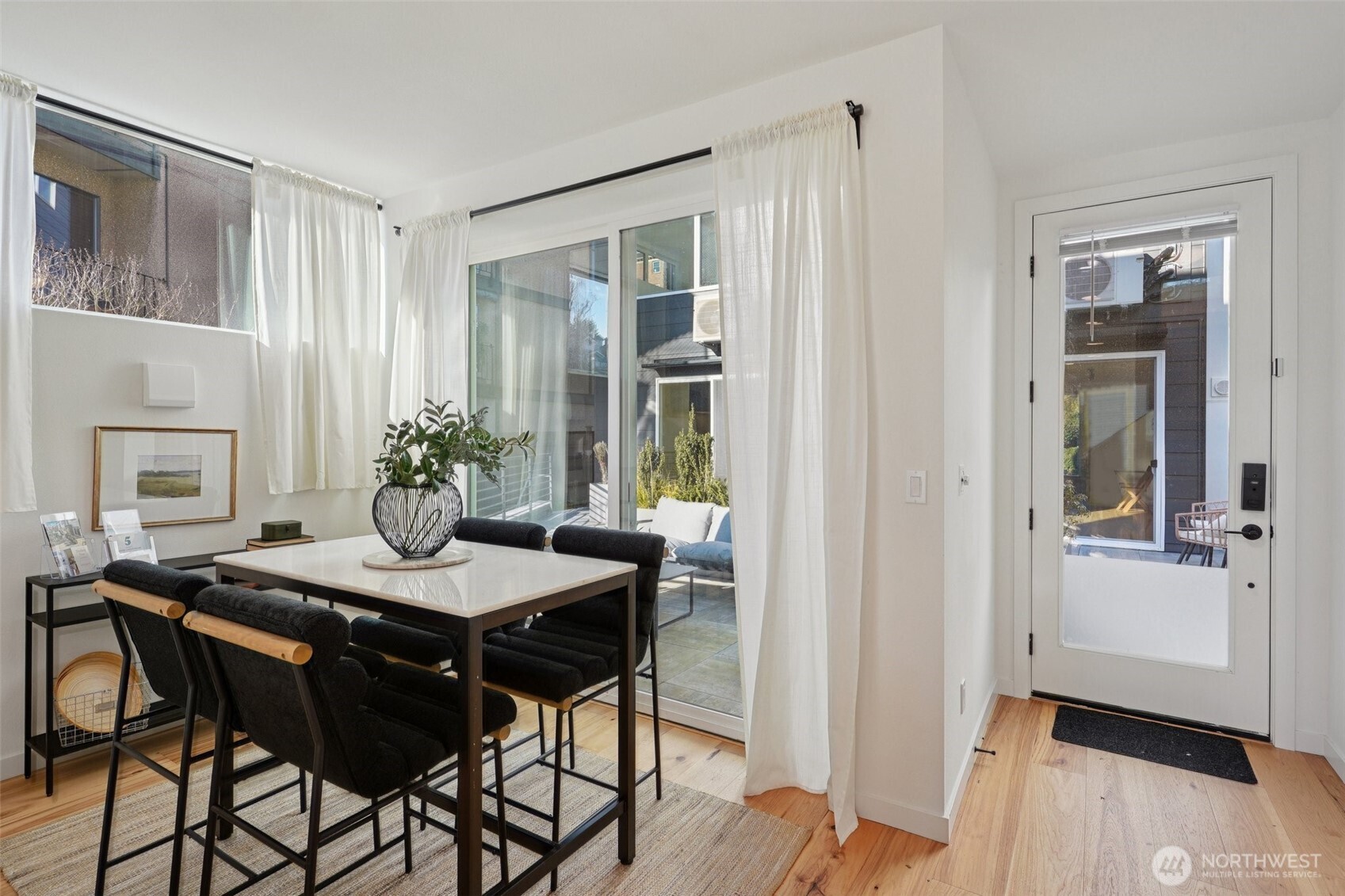 515 Howe Street, Unit A Seattle, WA 98109 - Photo 3 of 40 a view of a dining room with furniture and window