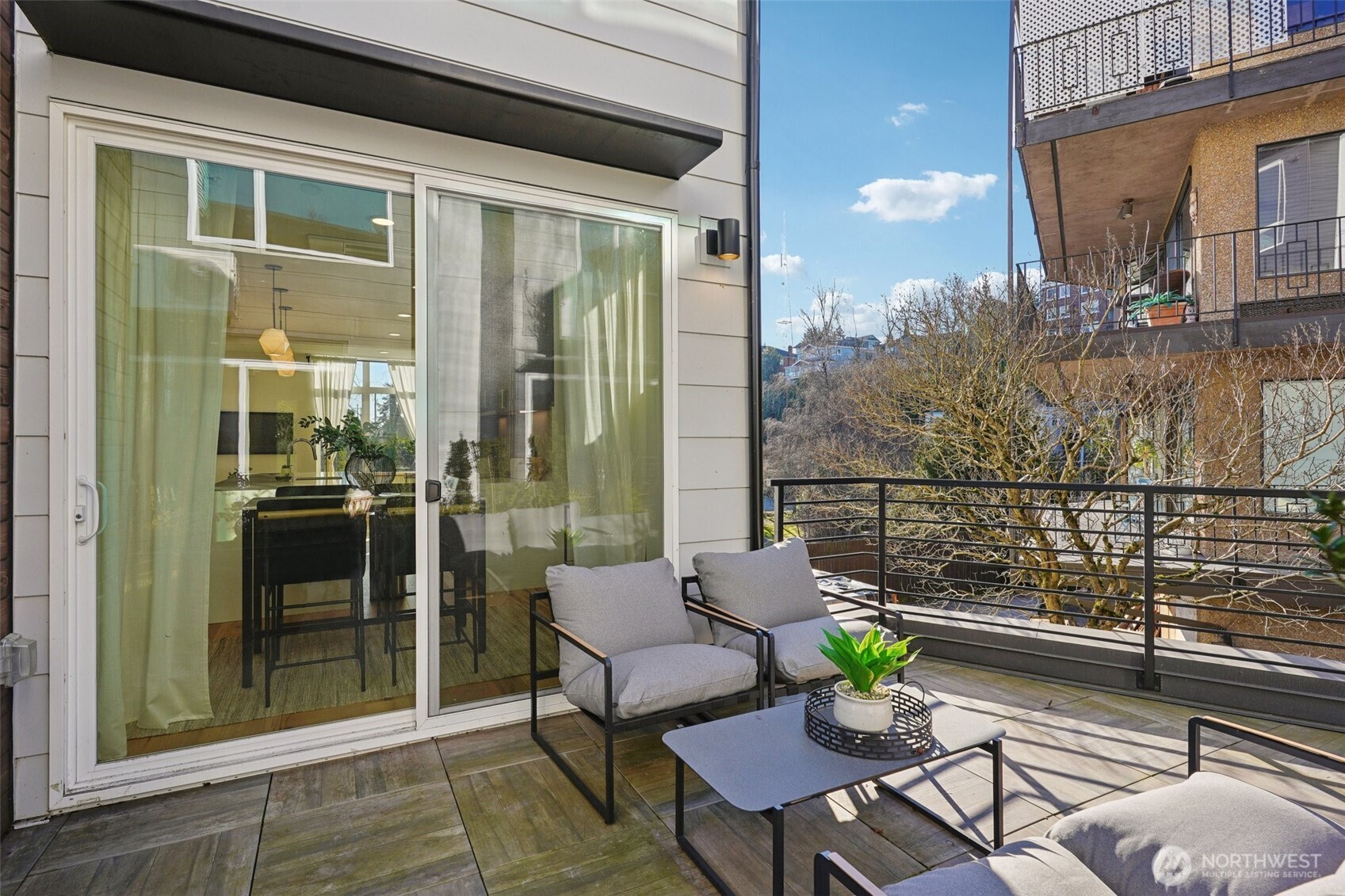 515 Howe Street, Unit A Seattle, WA 98109 - Photo 31 of 40 a view of a balcony dining area and glass windows