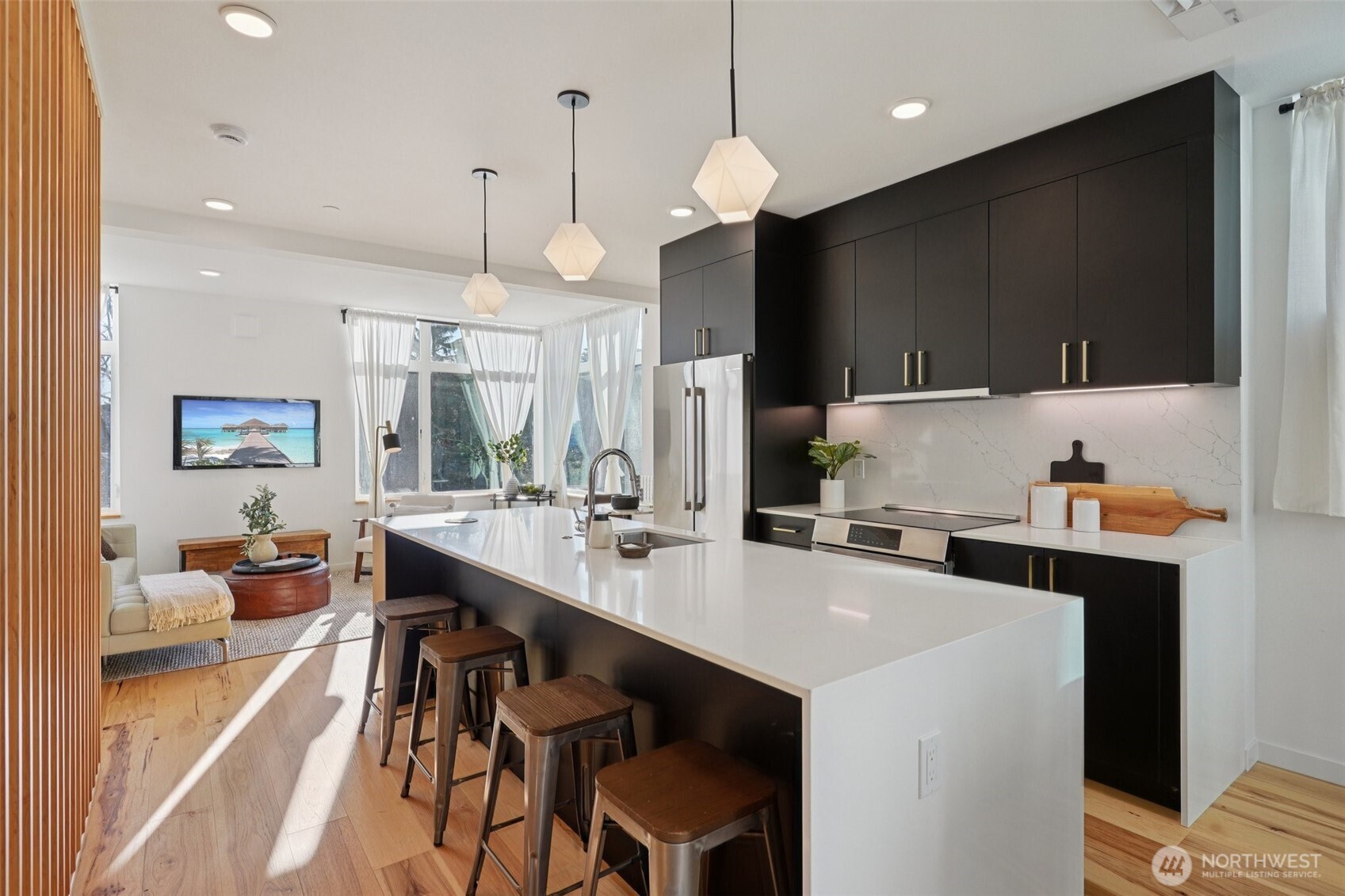 515 Howe Street, Unit A Seattle, WA 98109 - Photo 5 of 40 a kitchen with a stove a refrigerator a sink and chairs