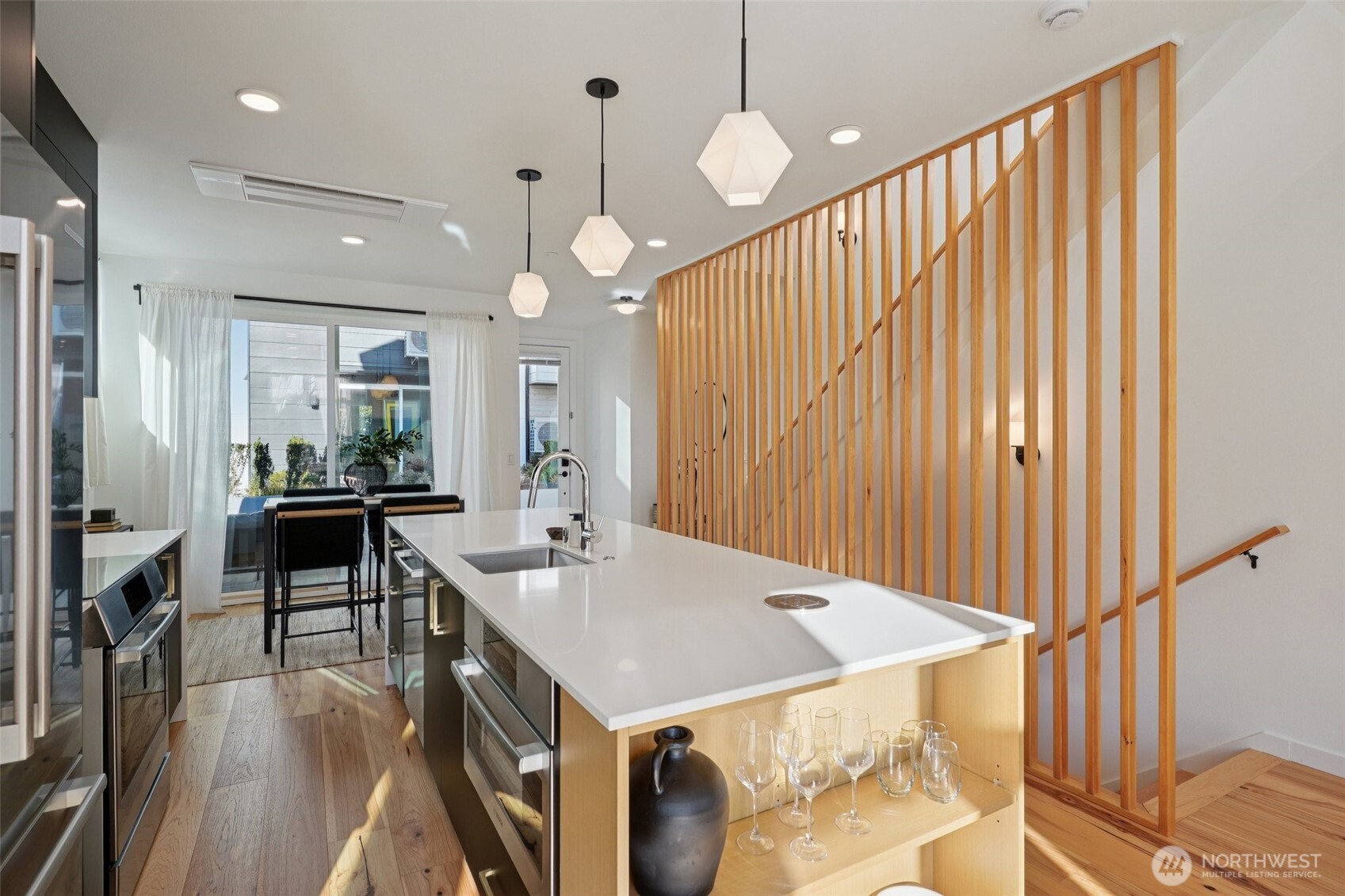515 Howe Street, Unit A Seattle, WA 98109 - Photo 6 of 40 a kitchen with stainless steel appliances granite countertop a sink a oven and a refrigerator