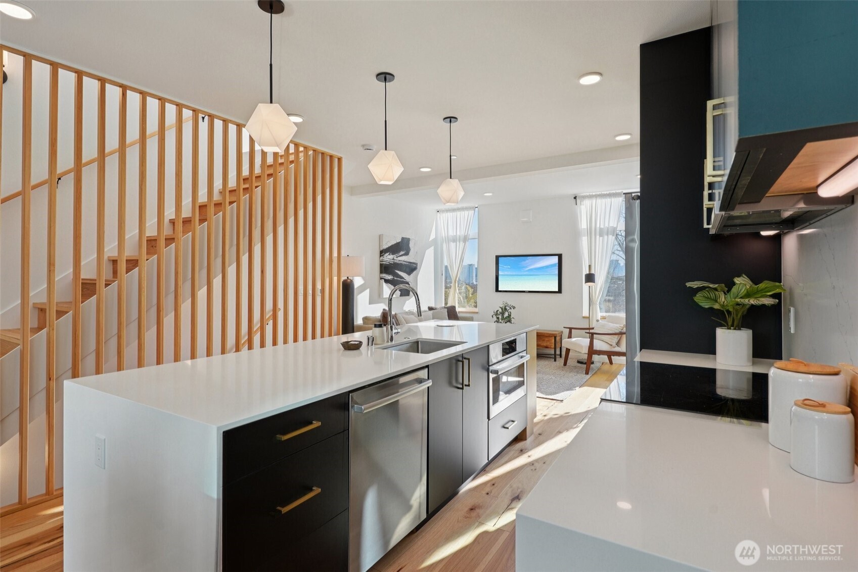 515 Howe Street, Unit A Seattle, WA 98109 - Photo 7 of 40 a kitchen with stainless steel appliances granite countertop a sink a stove and a wooden floors