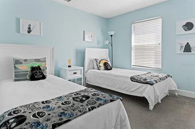 a bedroom with two beds and a couch