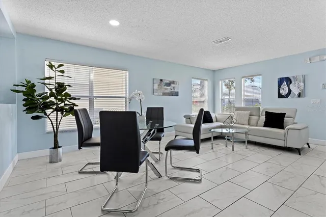 a living room with furniture potted plant and a window