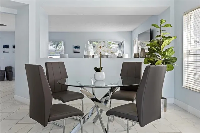 a dining room with furniture and window