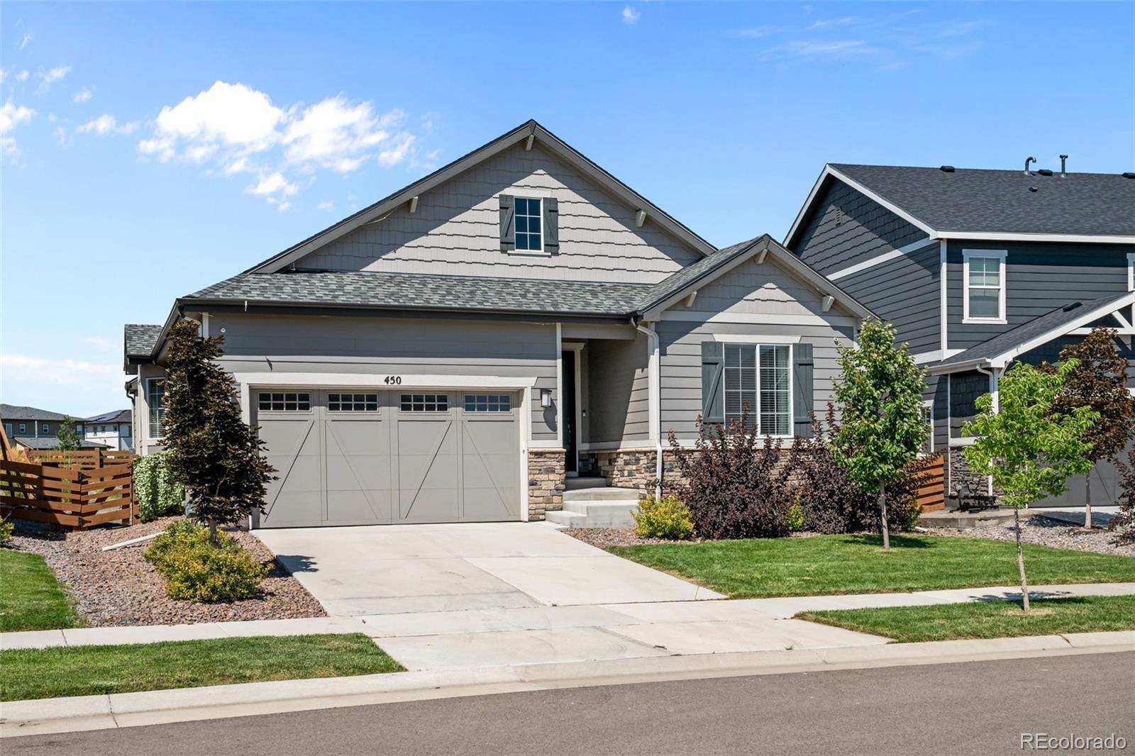 450 Pikes View Drive Erie, CO 80516 - Photo 1 of 45 a front view of a house with a garden