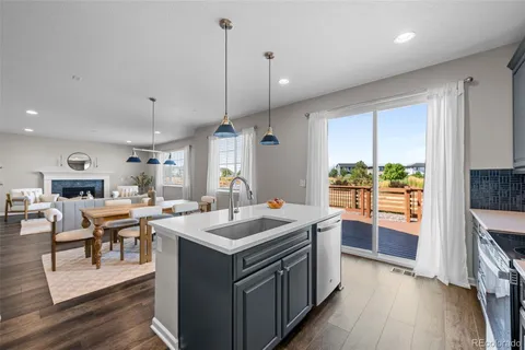 a open kitchen with stainless steel appliances granite countertop a stove and a refrigerator