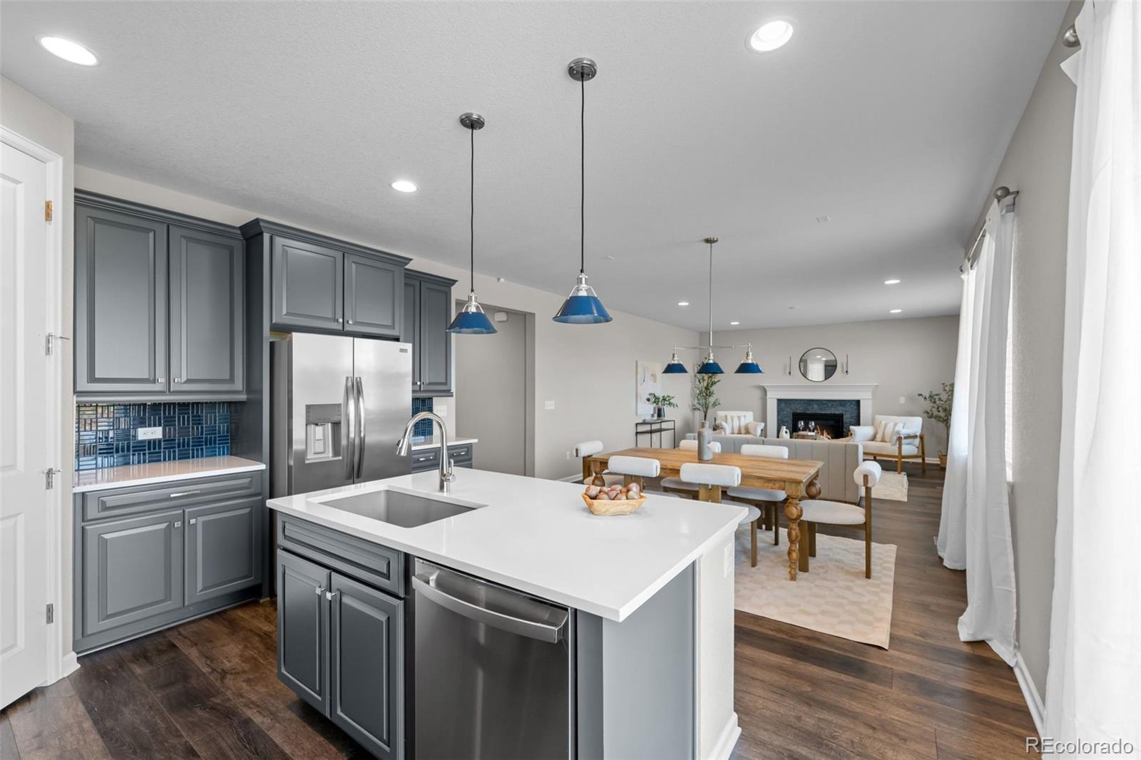 450 Pikes View Drive Erie, CO 80516 - Photo 17 of 45 a kitchen with kitchen island a sink appliances and a counter top space
