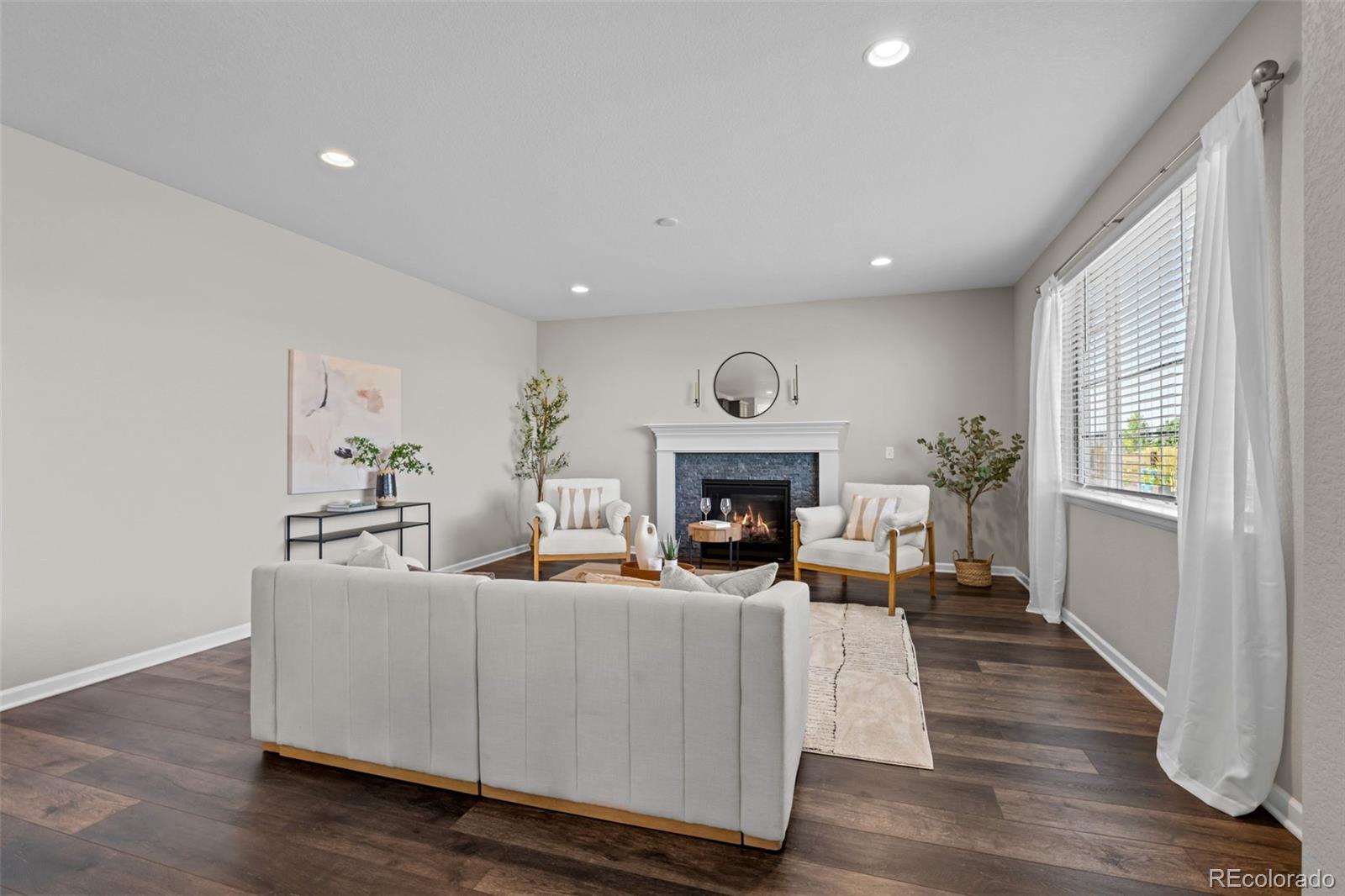 450 Pikes View Drive Erie, CO 80516 - Photo 20 of 45 a living room with furniture and a fireplace