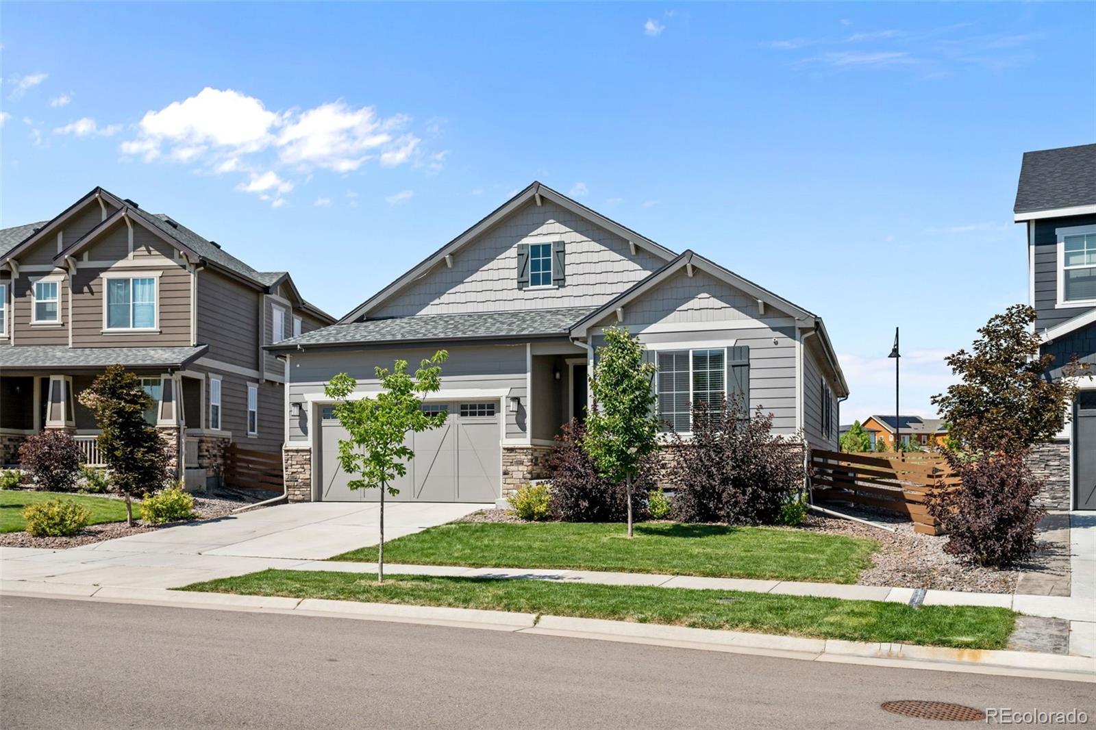 450 Pikes View Drive Erie, CO 80516 - Photo 2 of 45 a front view of a house with a yard and potted plants