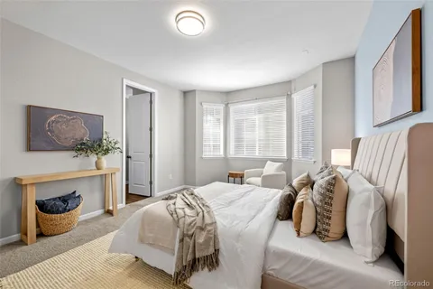 a bedroom with a bed and glass window
