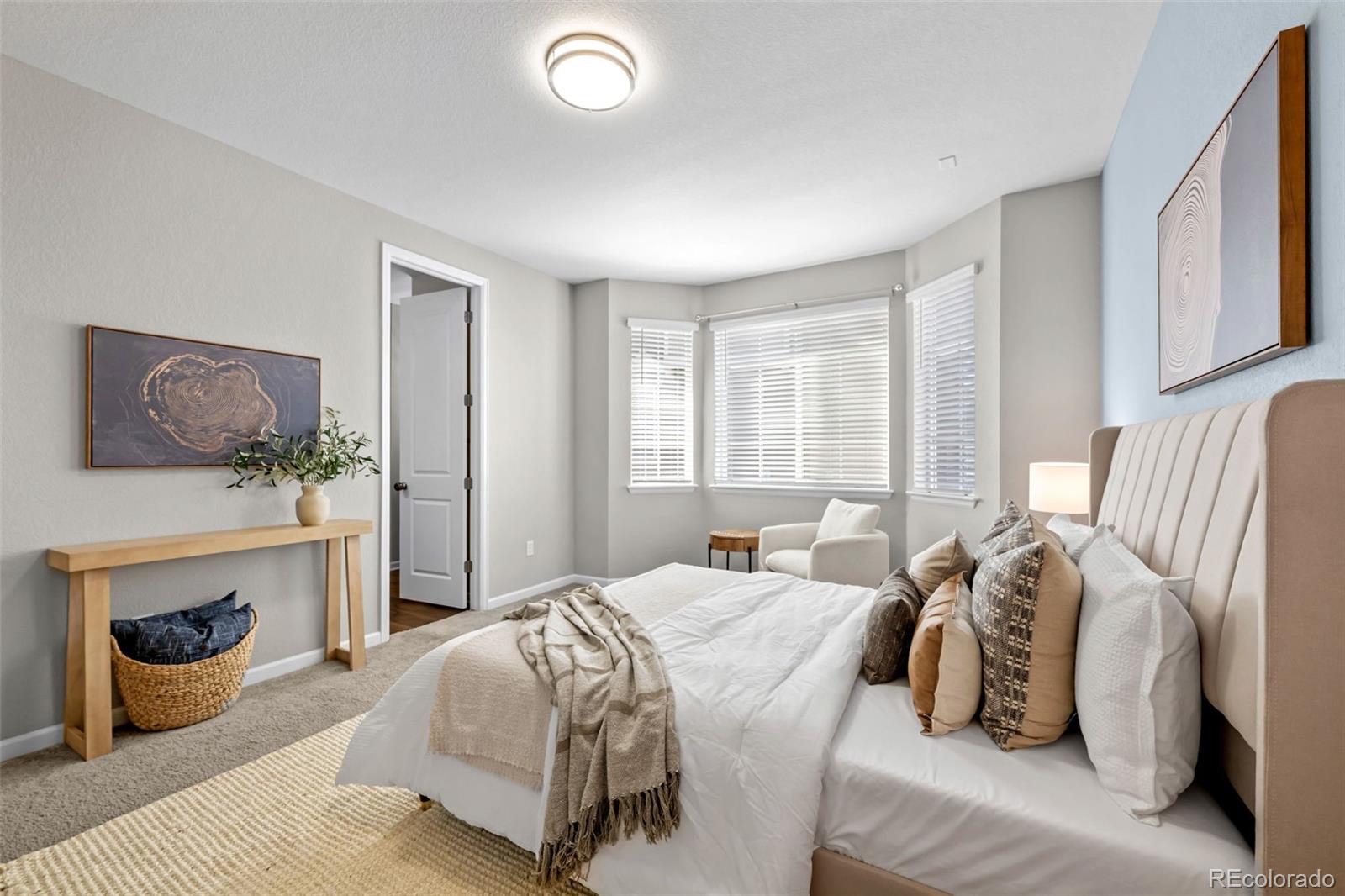 450 Pikes View Drive Erie, CO 80516 - Photo 24 of 45 a bedroom with a bed and glass window