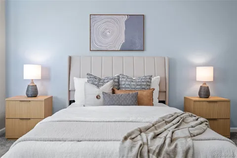 a bedroom with a bed and a lamp with the bathroom