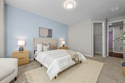 a bedroom with a bed and a couch