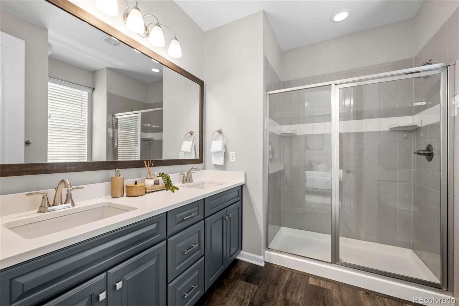 450 Pikes View Drive Erie, CO 80516 - Photo 27 of 45 a bathroom with a double vanity sink mirror and shower