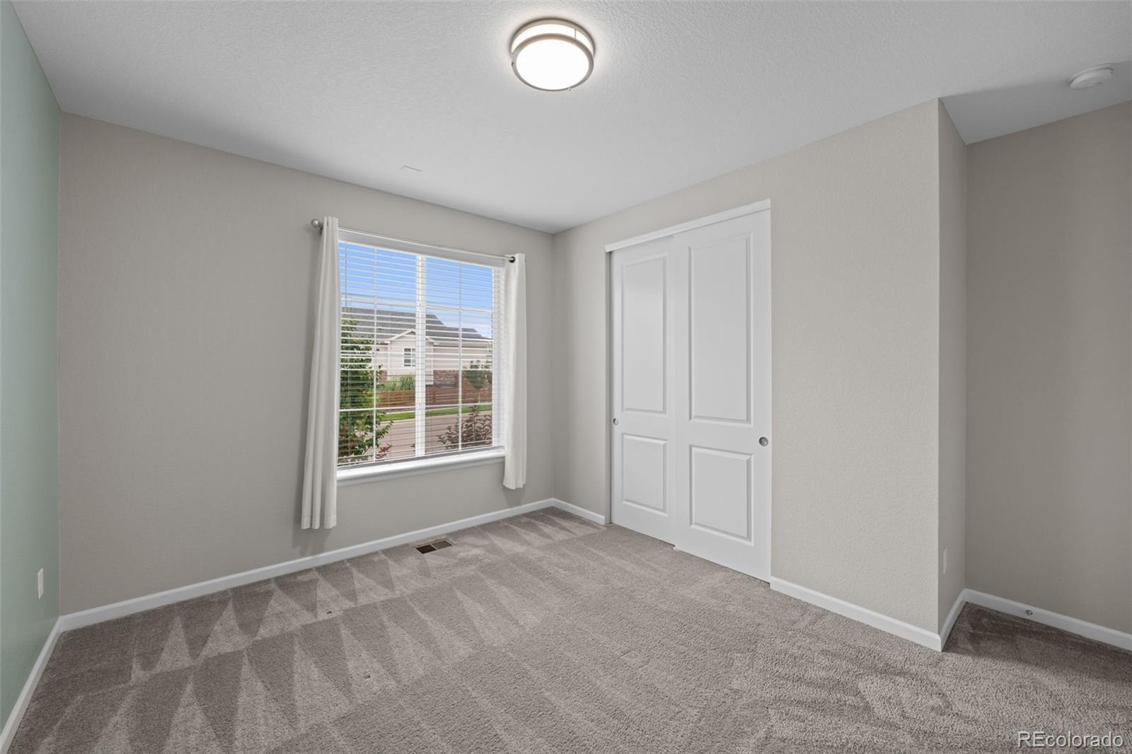 450 Pikes View Drive Erie, CO 80516 - Photo 29 of 45 a view of an empty room with a window